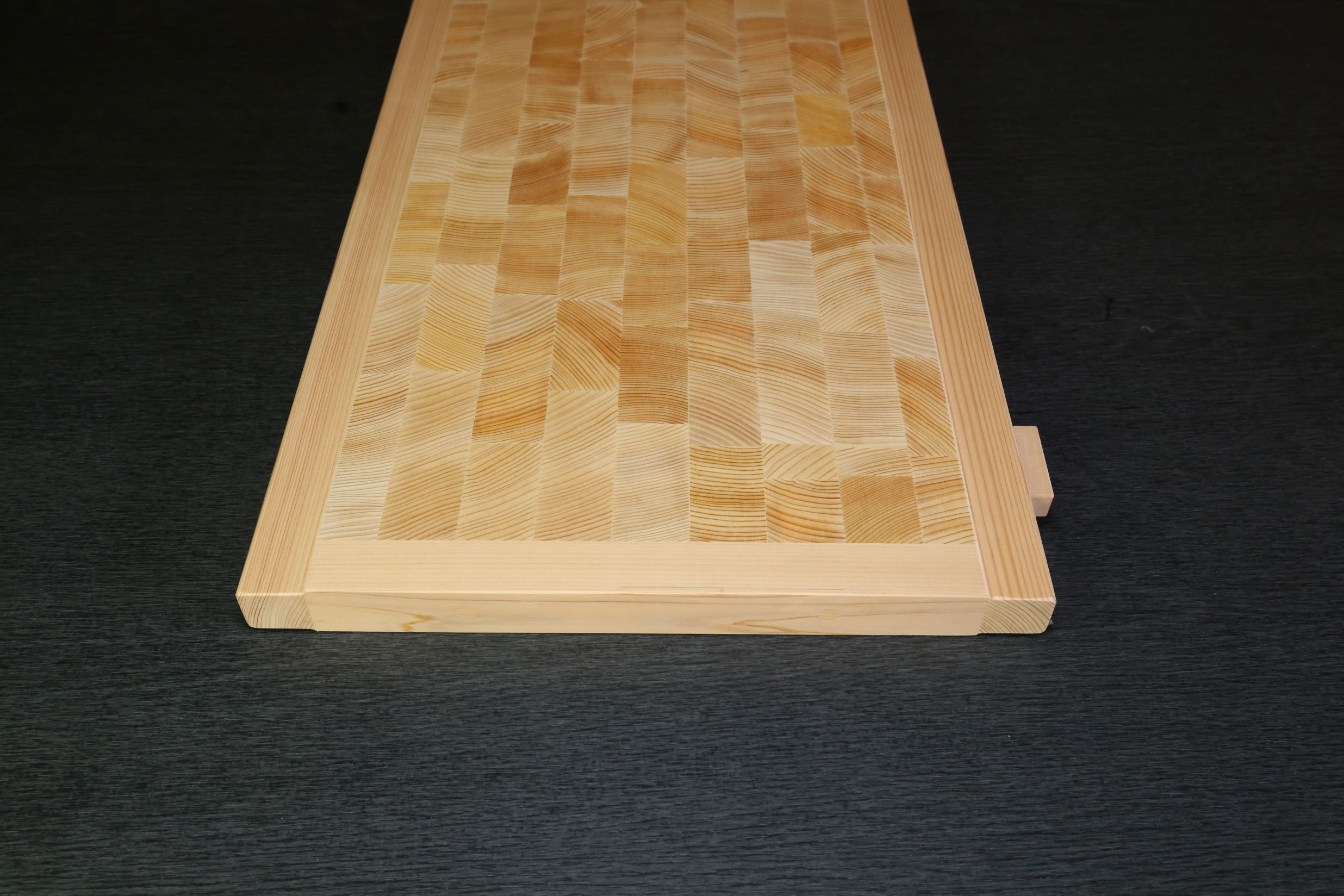 木曽椹(さわら)の角材を小口切りにして、その切り口を合わせた寄せ木づくりのまな板。長く使用しても減りが少なく、弾力性があります。
